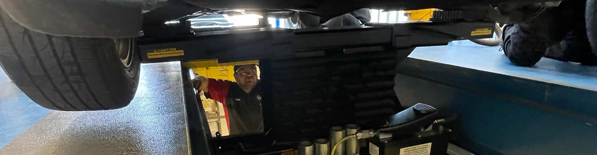 Mechanic under a vehicle